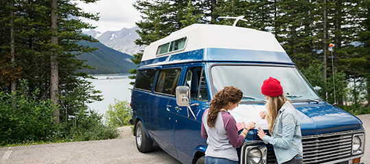 Campers on a road, reading a map.