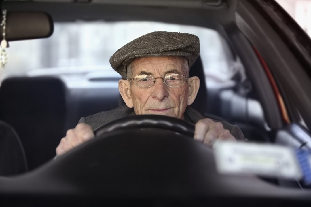 Elderly man driving.