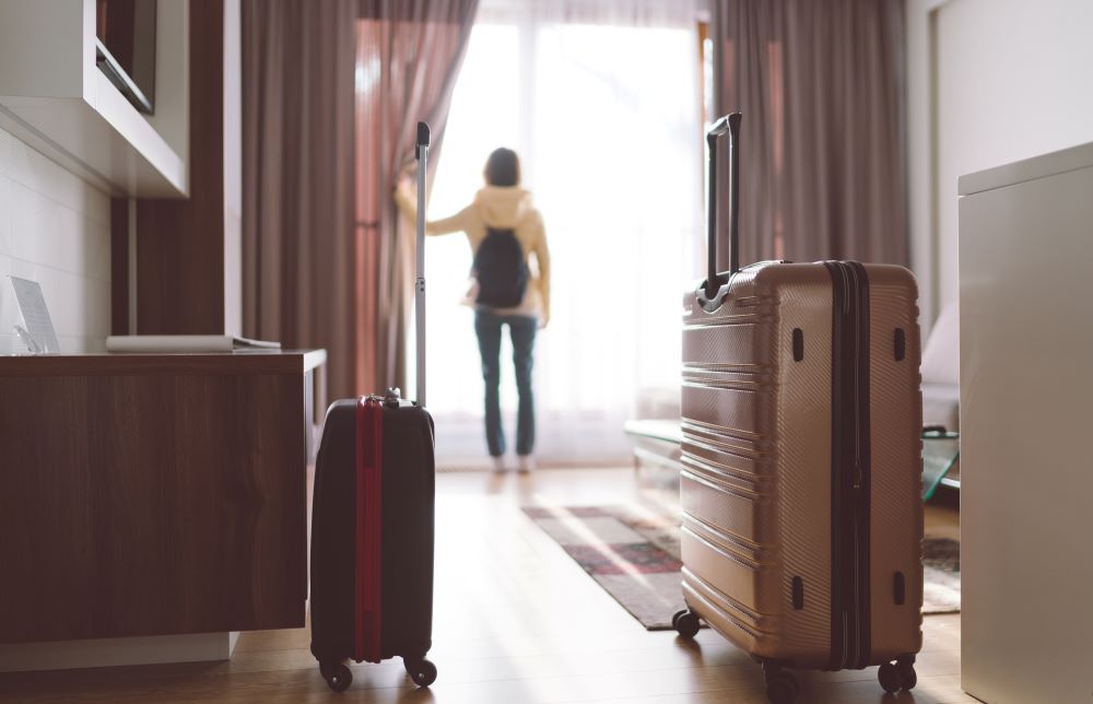 Woman checking in to hotel room.