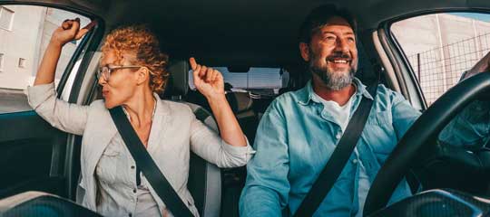 Couple driving in a vehicle.